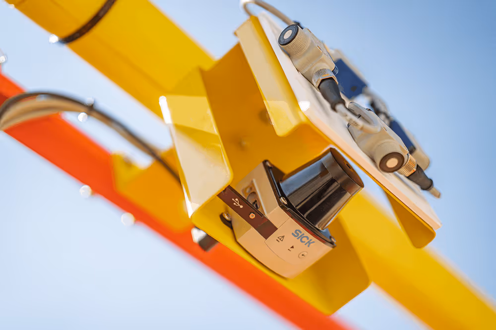 Close-up of a Bailey aerial lift basket and boom against a blue sky