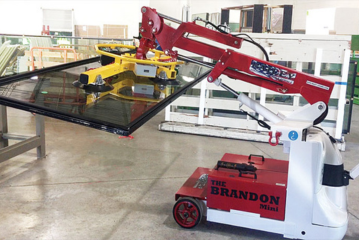The Brandon crane positioning a large glass panel in an interior installation