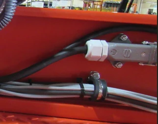 Close-up of the factory plug intercept routed through the Bailey controller