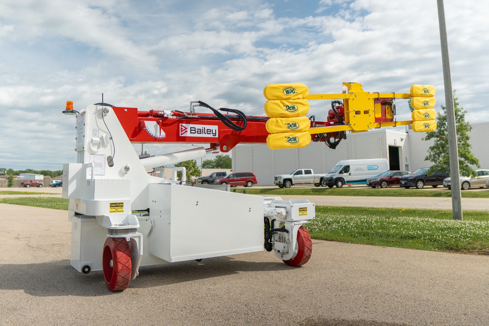 Bailey CH 6 OMNI battery-electric omni-directional compact handler staged outdoors with its boom raised
