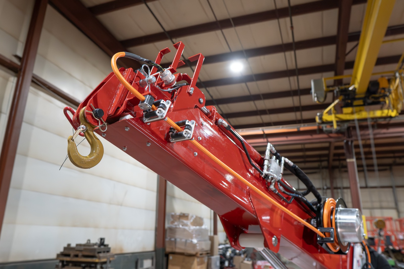 Close-up of the boom tip, load hook, and hydraulic lines on a Bailey pick-and-carry crane