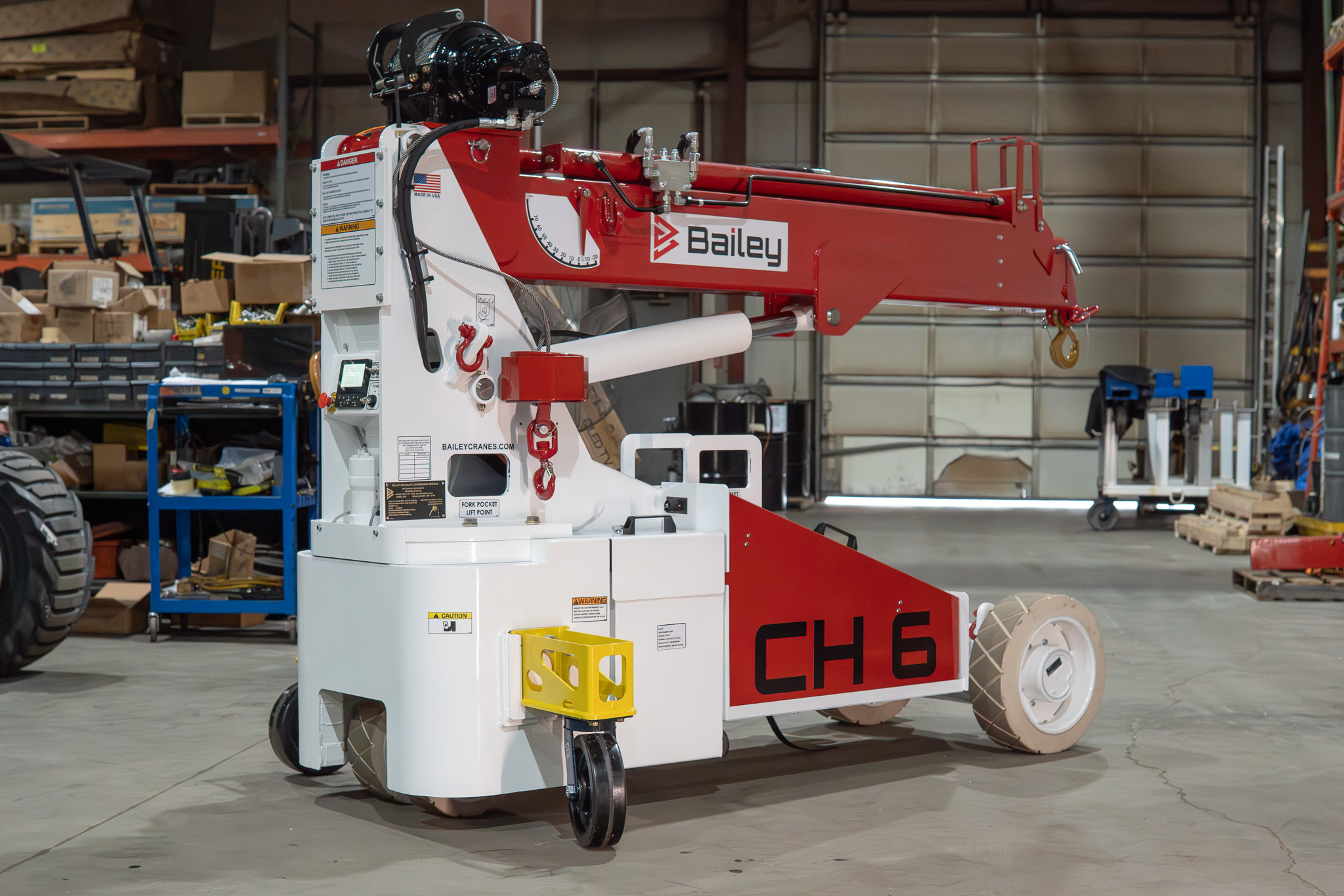 Compact mobile crane staged on a finished factory floor with attachment ready for an indoor lift